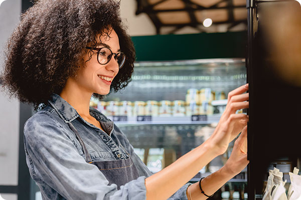smiling woman at a vending machine